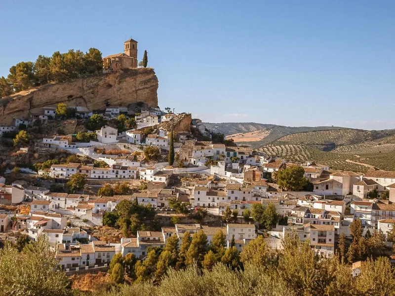 A hillside village surrounded by farmland in Andalusia